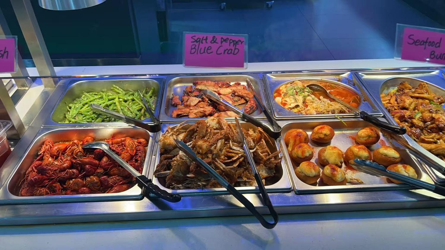 Trays filled with crayfish, blue crab and baked buns at YC Seafood Hot Pot, a Hot Pot Restaurant in Virginia Beach