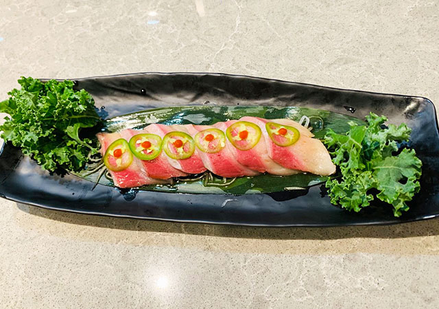 Sliced sashimi with jalapeño and kale garnish at Yosuki Sushi，a Japanese Restaurant in Staten Island