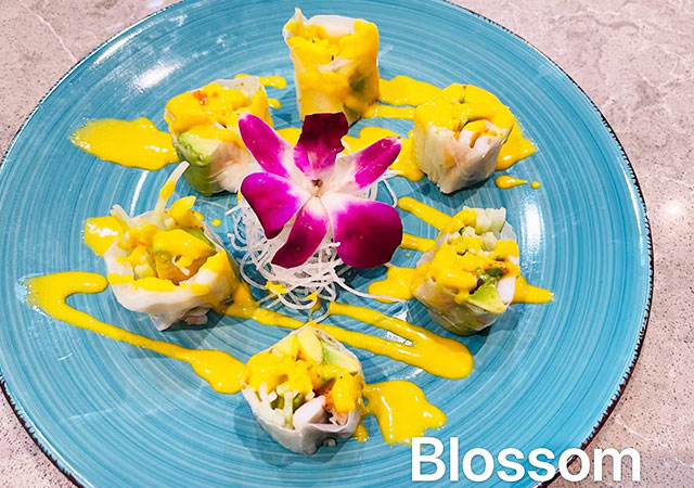 Fresh spring rolls with mango sauce and orchid garnish at Yosuki Sushi，a Japanese Restaurant in Staten Island