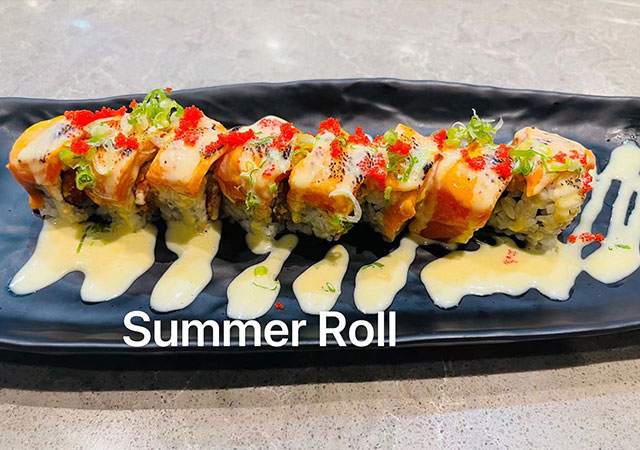 Summer Roll sushi with salmon, tobiko and creamy sauce at Yosuki Sushi，a Japanese Restaurant in Staten Island