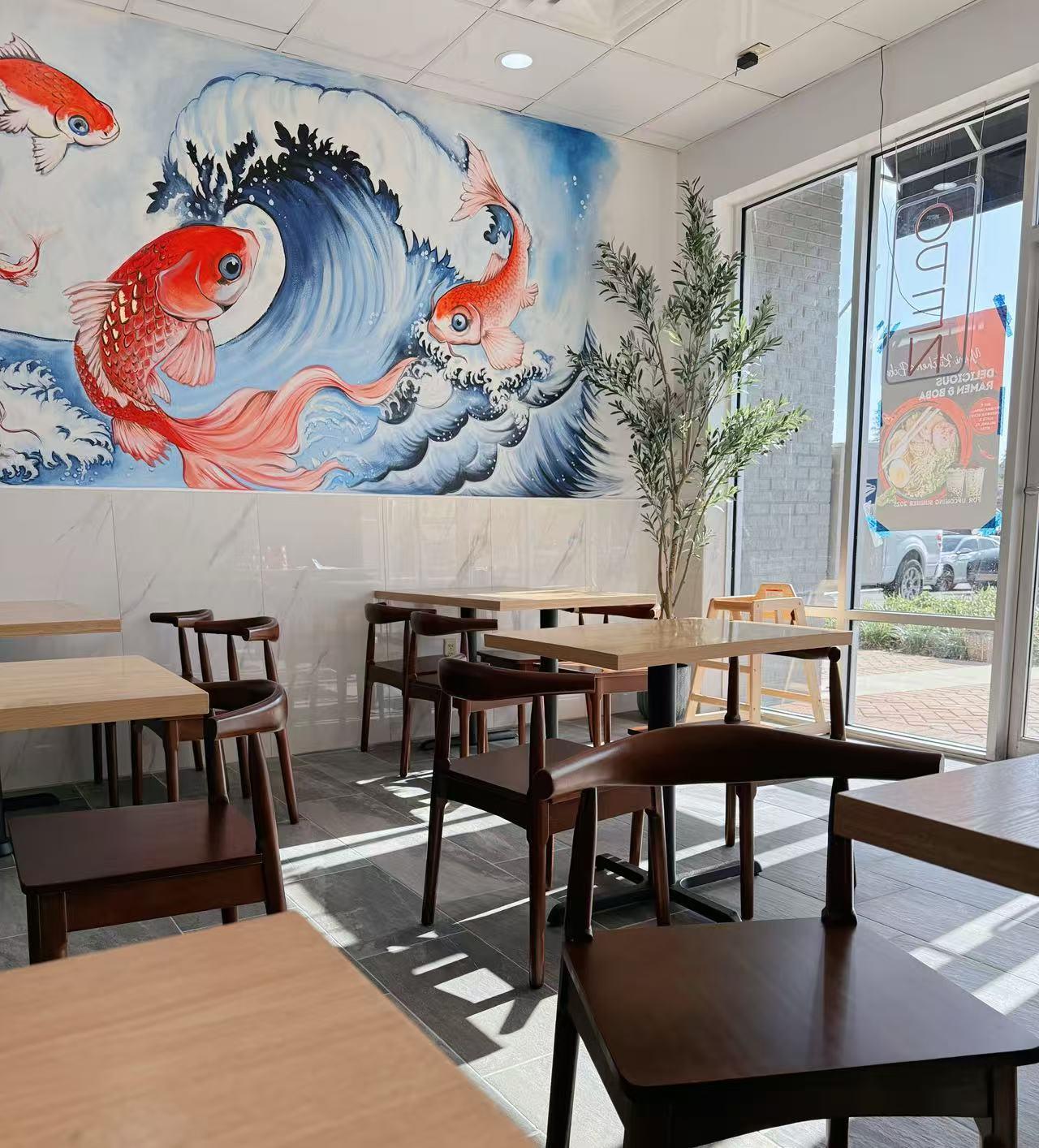 Yumi-Kitchen-&-Boba-Asian-Fusion-restaurant-Restaurant-Interior-DeLand Restaurant Interior - Cozy dining area with wooden tables, chairs and a wall mural of koi fish and waves at Yumi Kitchen & Boba, a Asian fusion restaurant in DeLand