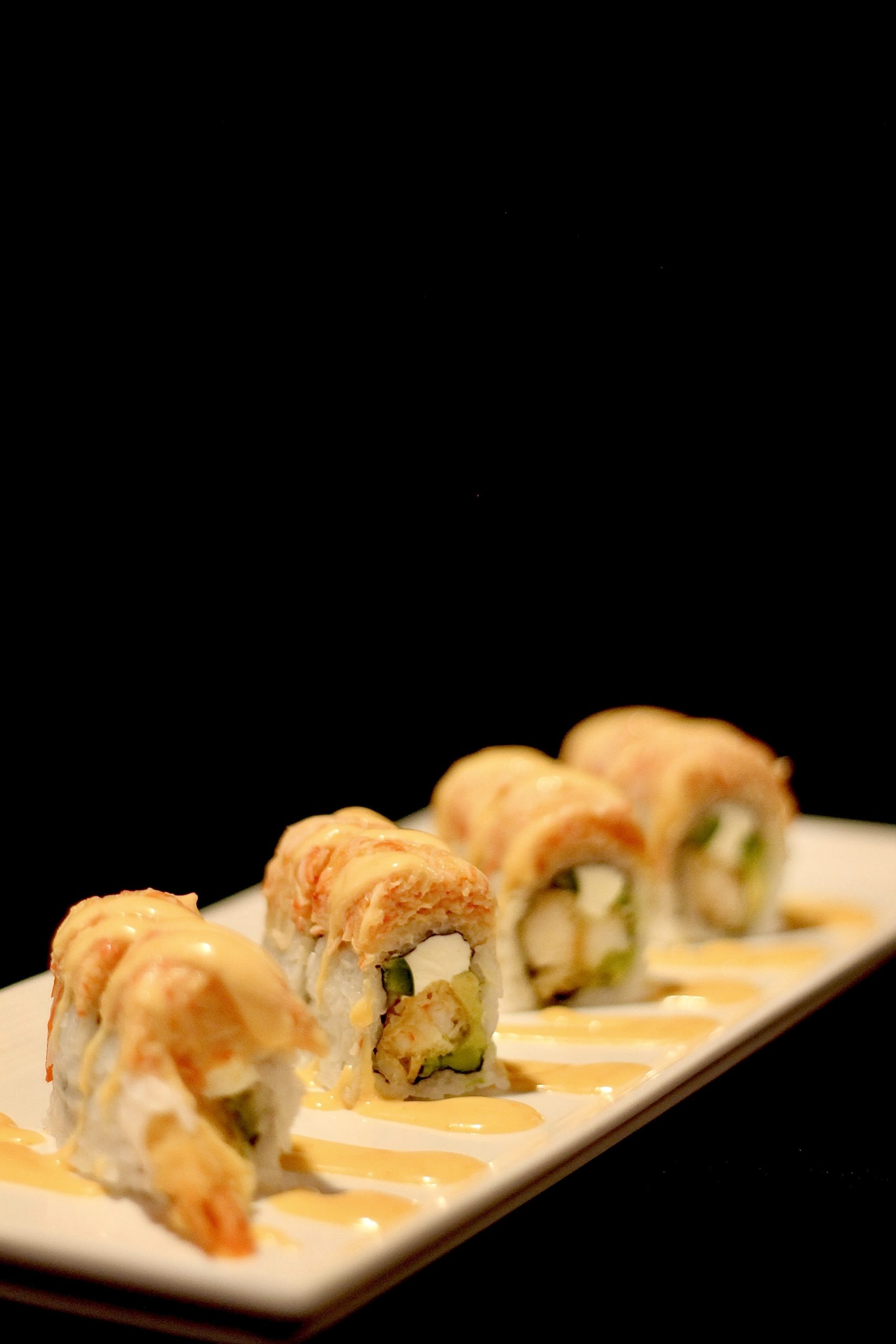 Seafood tempura sushi roll with spicy sauce at Yummi Yummi Mongolian Grill & Sushi, a Asian Fusion Restaurant in College Station