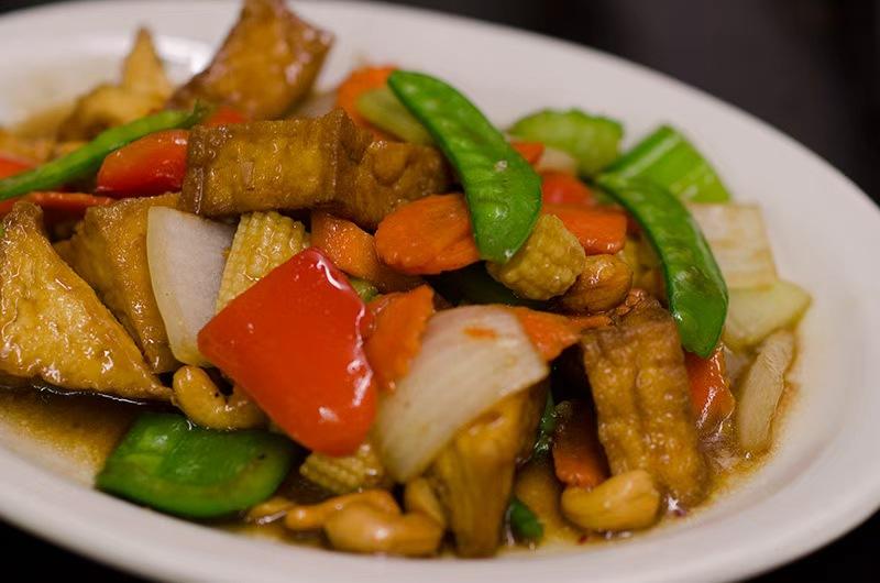 Tofu and veggies stir - fried in savory sauce at Yummy Express, a Asian Restaurant in Punta Gorda.
