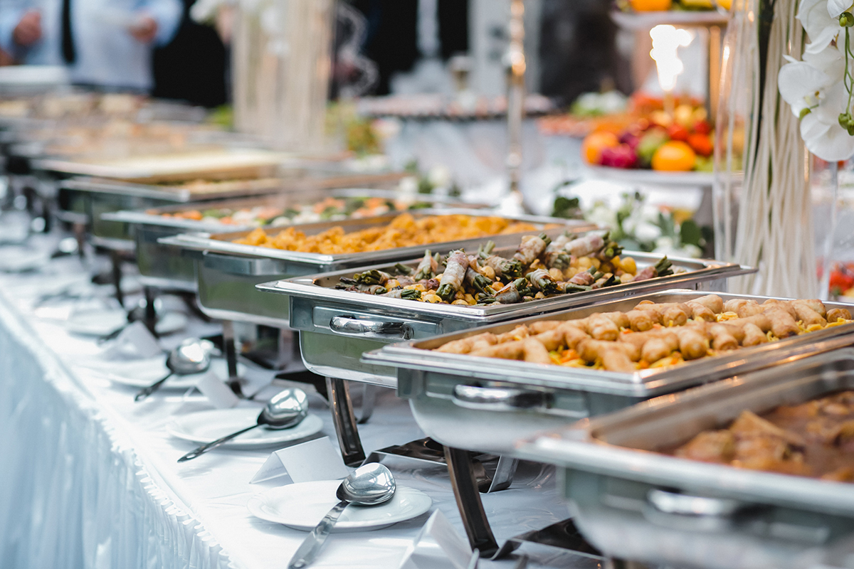 Elegant catered buffet line with wrapped vegetable rolls fried pastry trays at Yummy Buffet Asian Cuisine, an Asian Restaurant in Sikeston