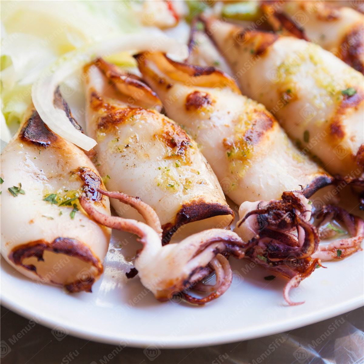 Grilled Squid - Tender grilled squid with herbs and lemon at Yummy Crab, a Seafood Restaurant in Houston