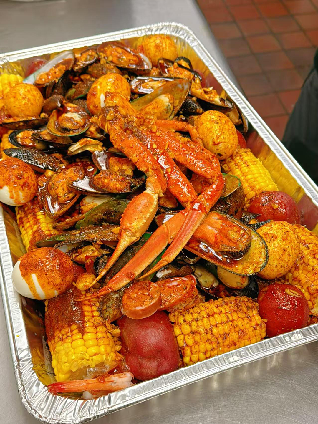 Yummy-Crab-Seafood-Restaurant-Seafood-Boil-with-Corn-and-Vegetables-Charlotte Seafood boil with corn and vegetables from Yummy Crab, a seafood restaurant in Charlotte