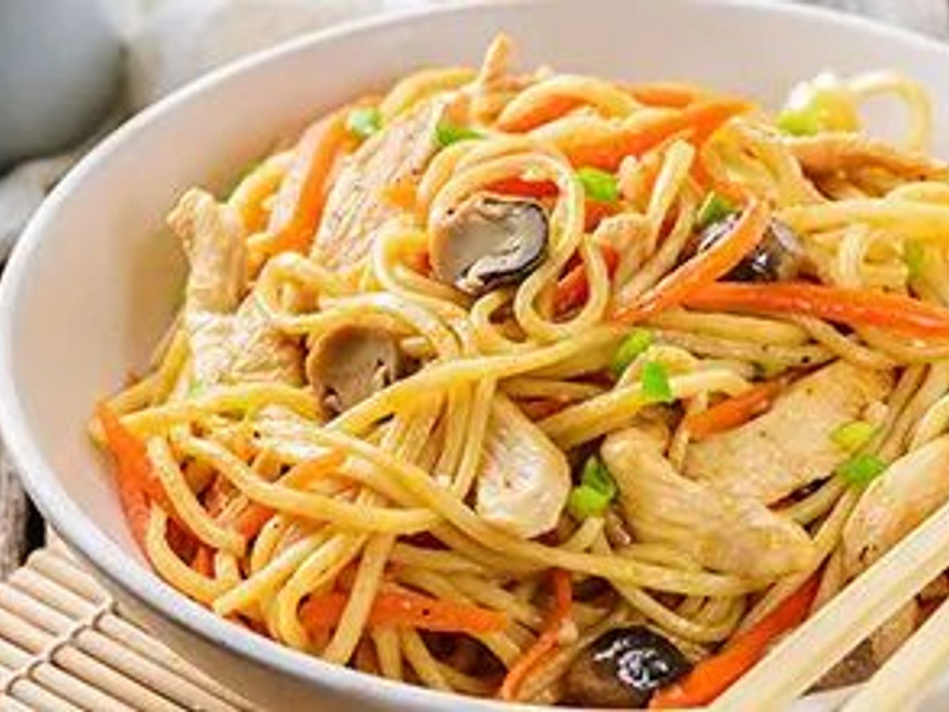 Chicken stir-fried noodles with mushrooms, carrots and green onions