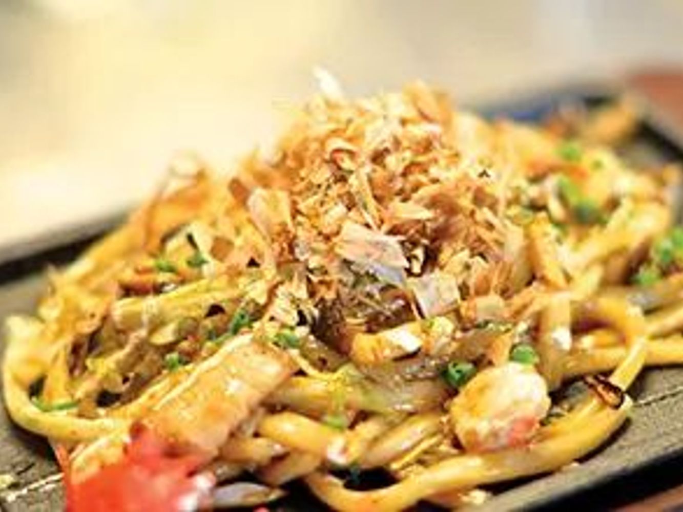 Seafood yaki udon noodles topped with crispy bonito flakes