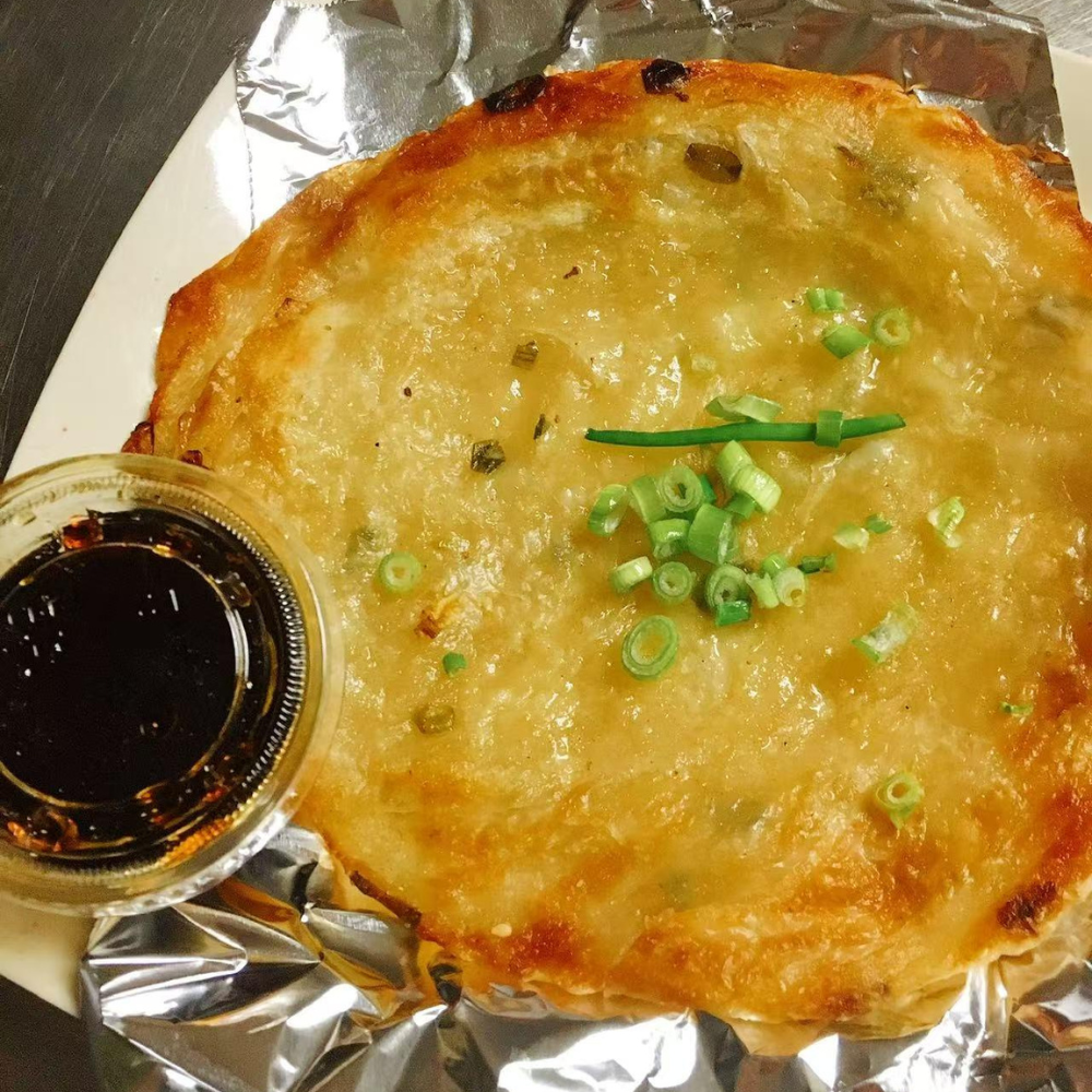 Flaky scallion pancake with dipping sauce at Yummy House, a Asian Restaurant in Athens.