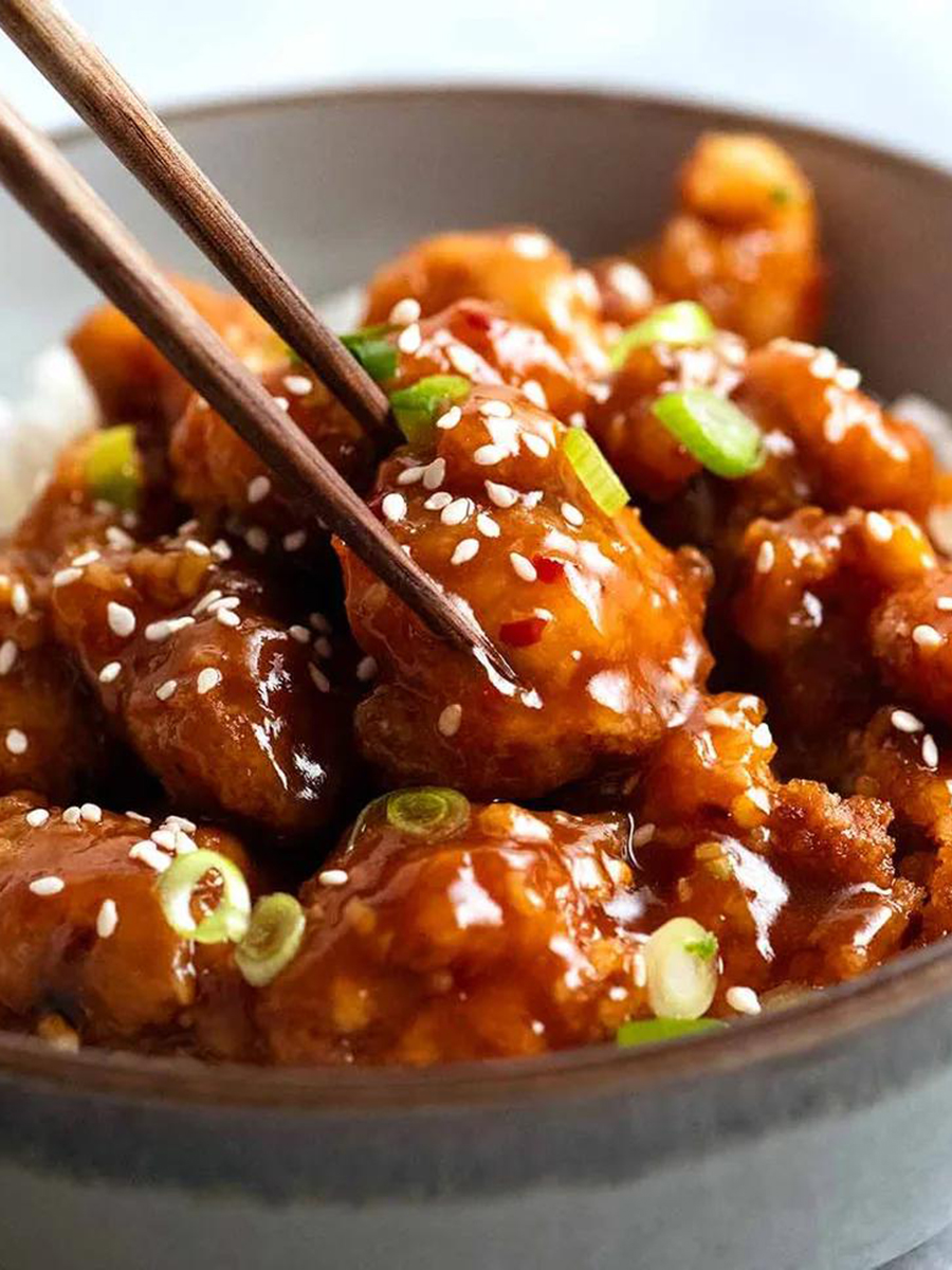 Sweet and Sour Chicken Cubes, crispy - coated chicken pieces smothered in a glossy, tangy - sweet sauce, sprinkled with sesame seeds and scallions at Yummy House，a Chinese Restaurant in Oklahoma City