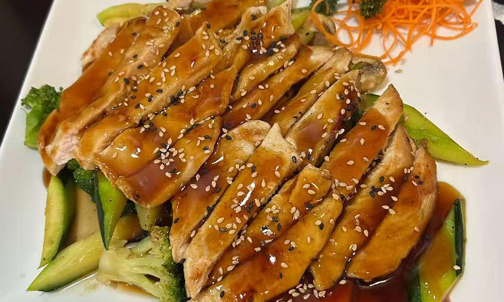 Grilled teriyaki chicken with sesame seeds over mixed vegetables at Yu San, a Japanese Restaurant in East Stroudsburg