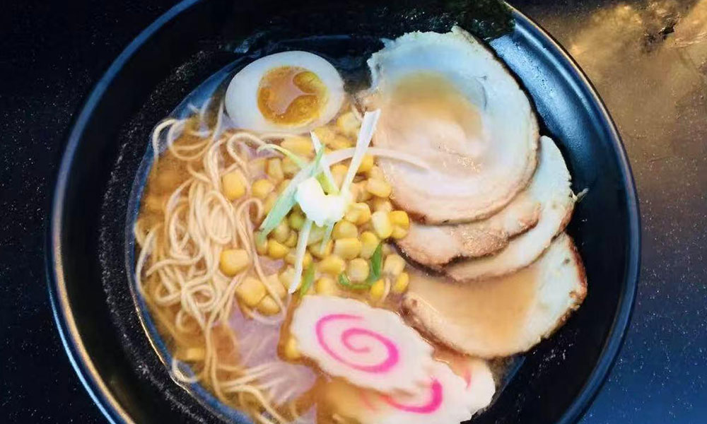 Clear broth ramen with chashu, corn, narutomaki, and soft-boiled egg at Yu San, a Japanese Restaurant in East Stroudsburg