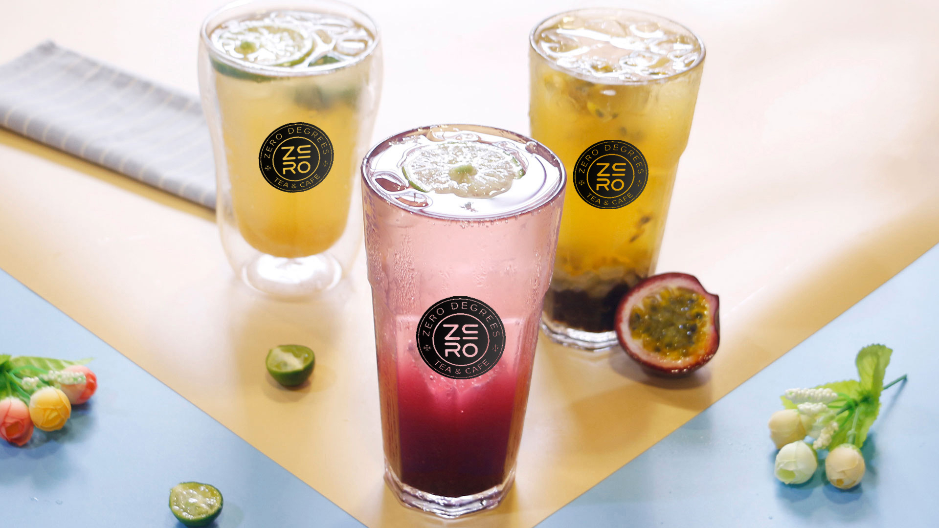 Zero-Degrees-Asian-inspired-Drink & Snack-Shop-Three-drinks-Bloomington Three drinks including lime special drink, passion fruit special drink, and pink specialty sparkling water, with fruits and flowers as decorations at Zero Degrees,a Asian-inspired Drink & Snack Shop in Bloomington