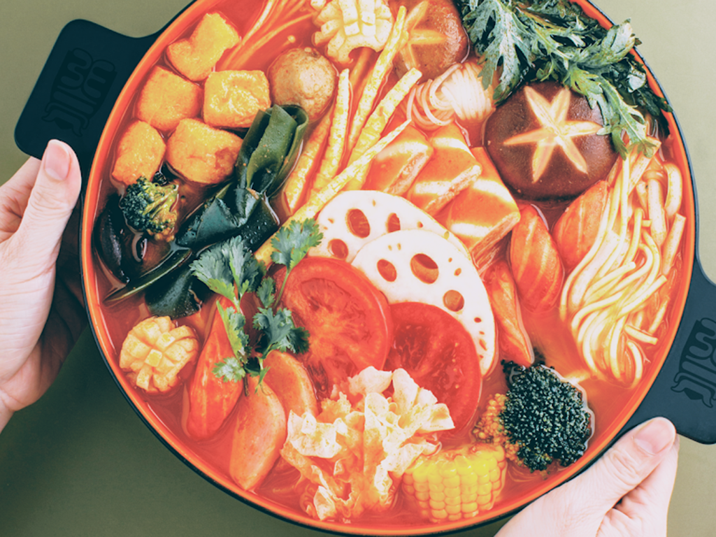 Colorful tomato mala bowl with fresh veggies and assorted ingredients at Zhangliang Malatang, a Chinese Restaurant in Mountain View