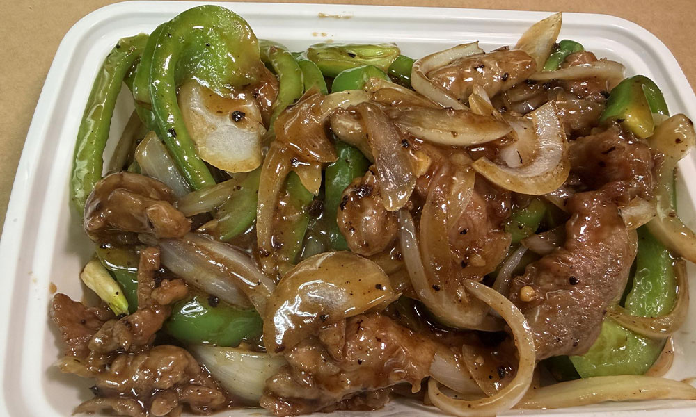 Beef stir-fry with green peppers and onions in savory brown sauce, takeout style.