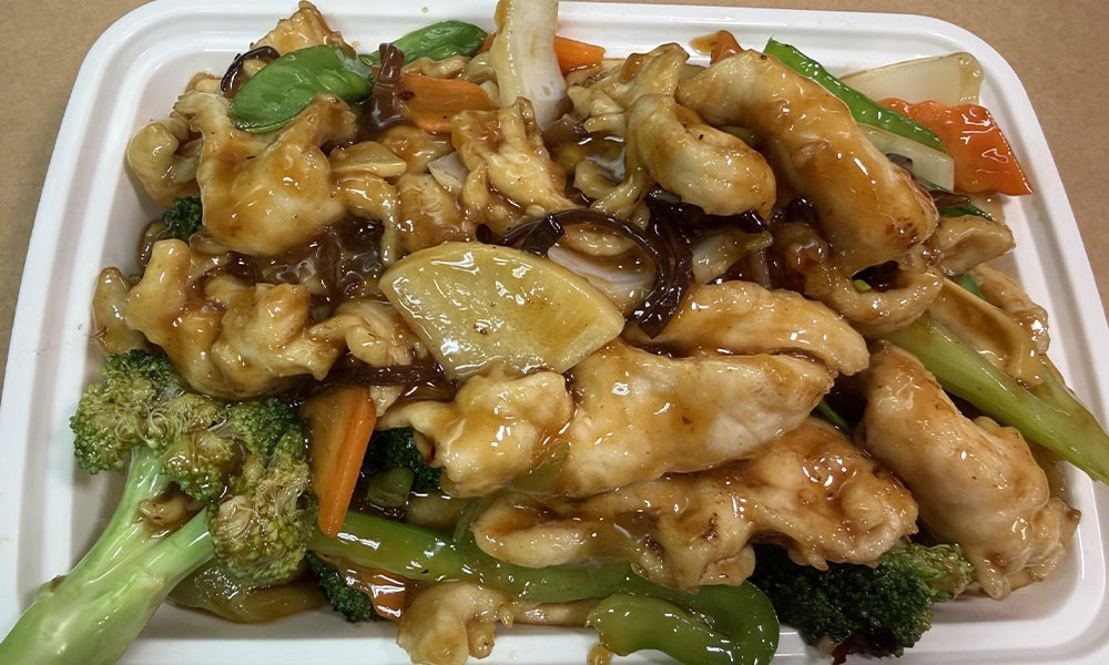 Chicken with mixed vegetables in brown sauce, classic Chinese takeout dish.