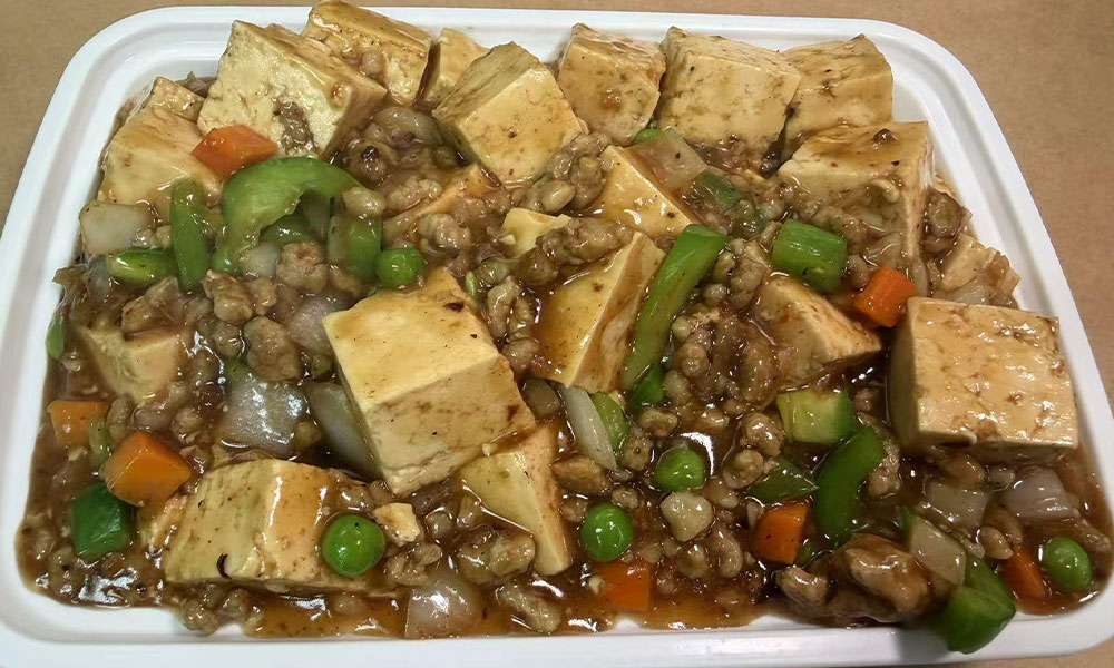 Mapo tofu with minced pork, peas, and peppers in spicy Sichuan sauce.