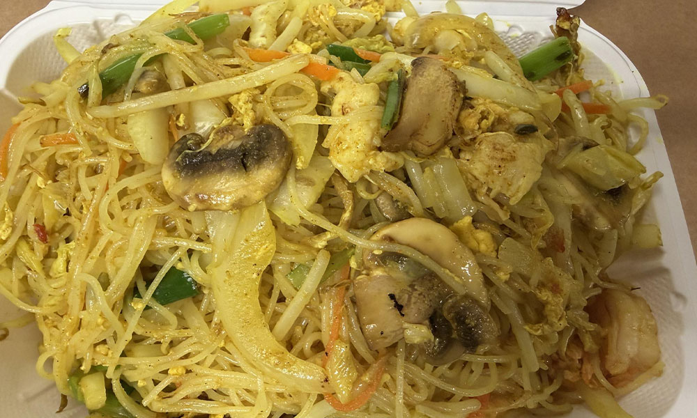 Singapore-style rice noodles with chicken, mushrooms, and egg stir-fry.