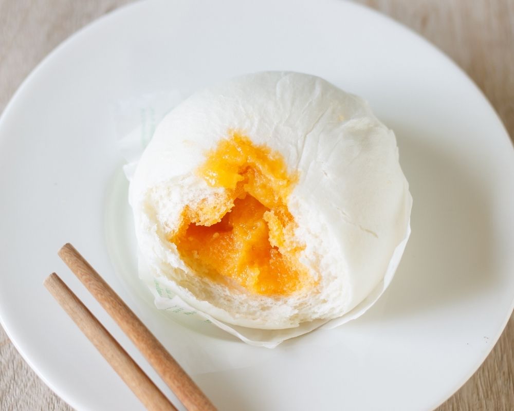 Creamy salted egg yolk bun, partially eaten at ZOEN RAMEN & POKE, Ramen Restaurant in College Station