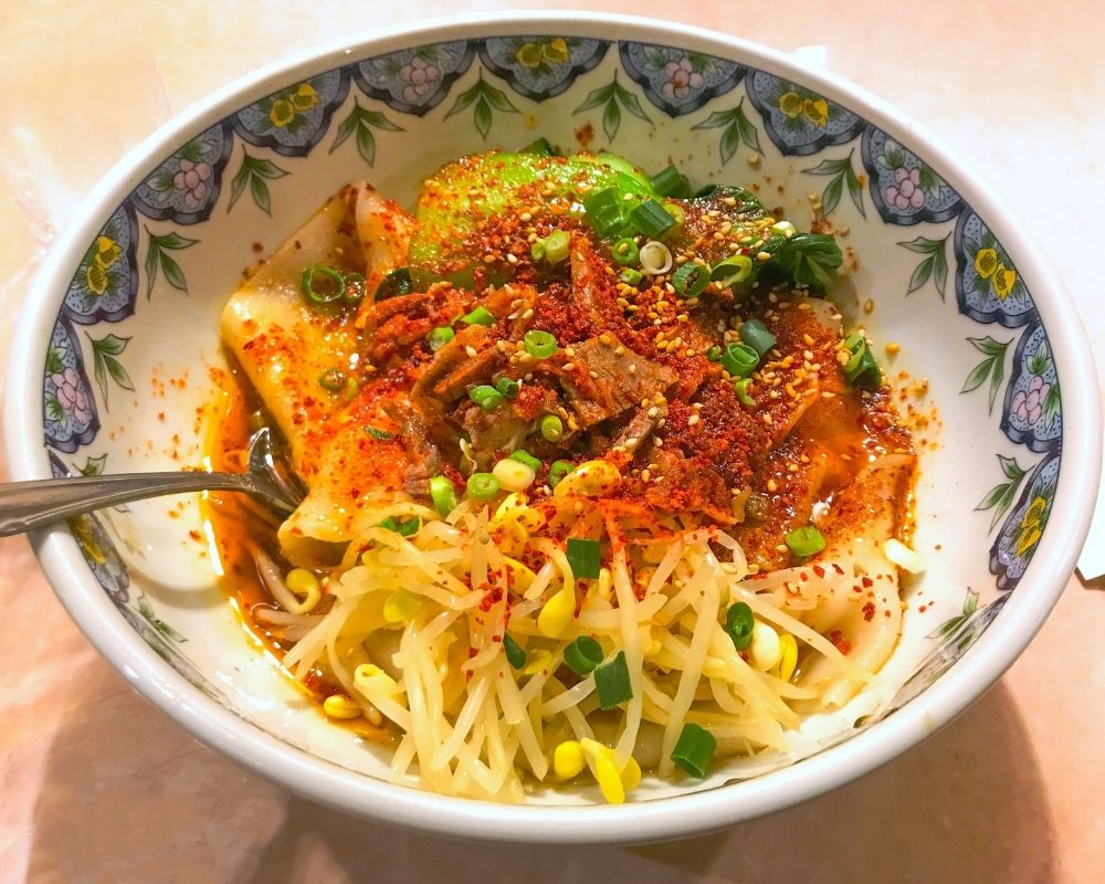 Spicy oil-poured noodles with bean sprouts at ZOEN RAMEN & POKE, Ramen Restaurant in College Station