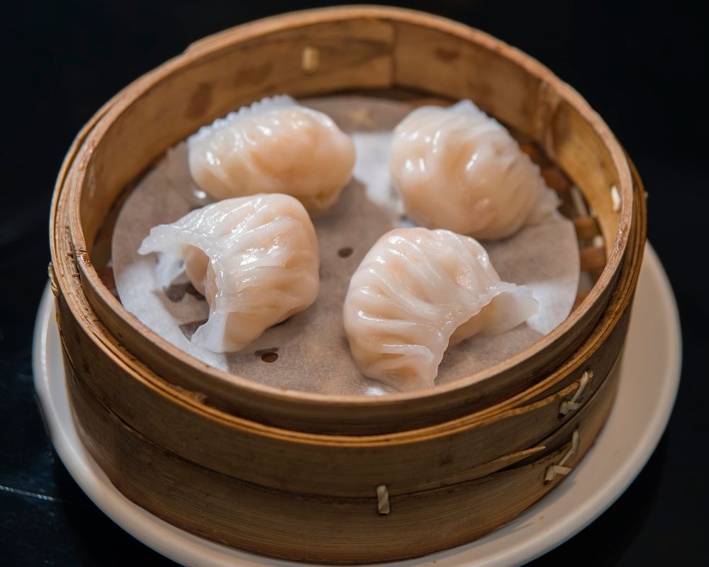 Steamed shrimp dumplings in bamboo steamer at ZOEN RAMEN & POKE, Ramen Restaurant in College Station