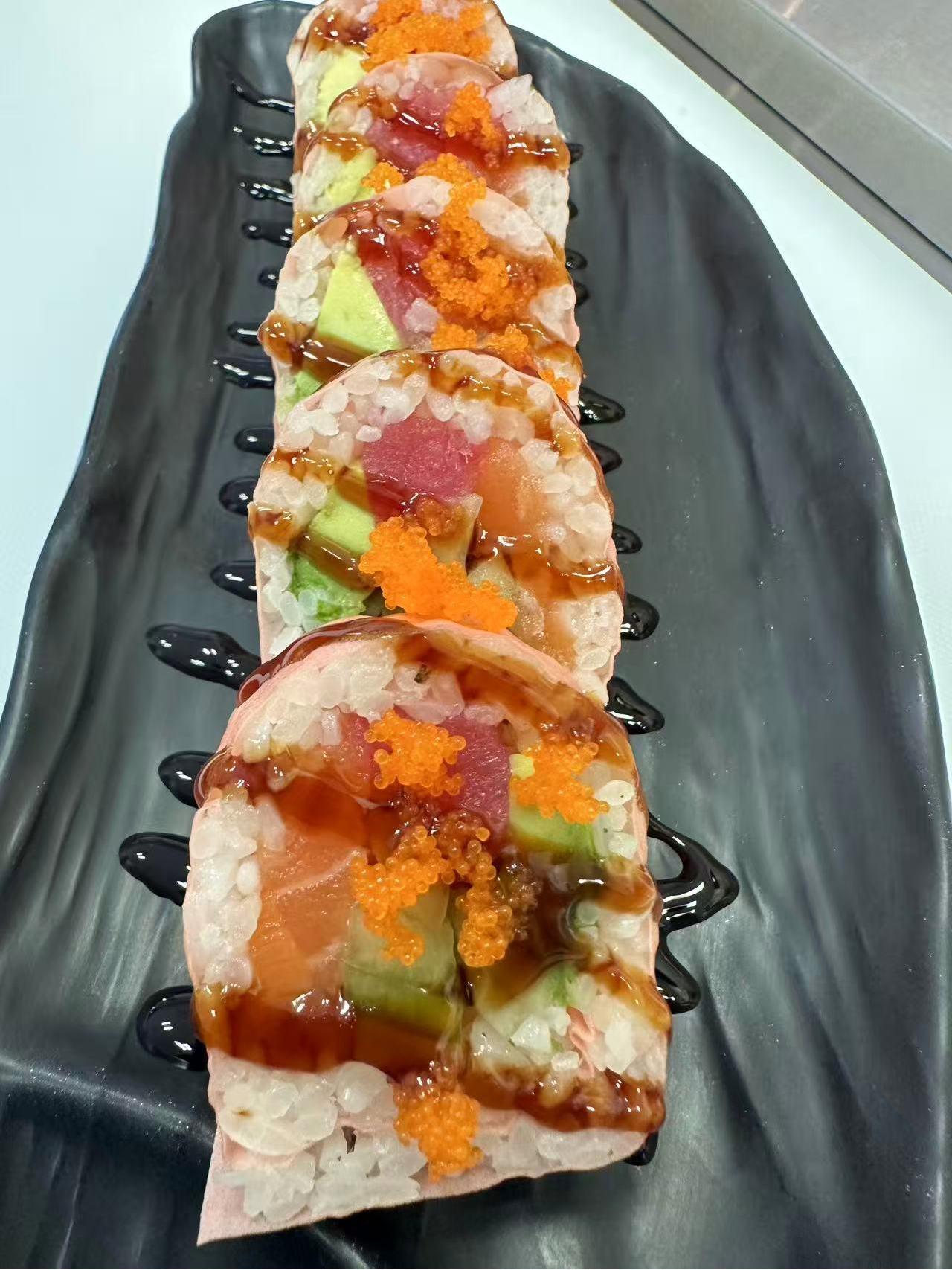 Crazy Sake Roll with spicy sauce and sesame seeds at ZX Sushi, a Japanese Restaurant in Milwaukee