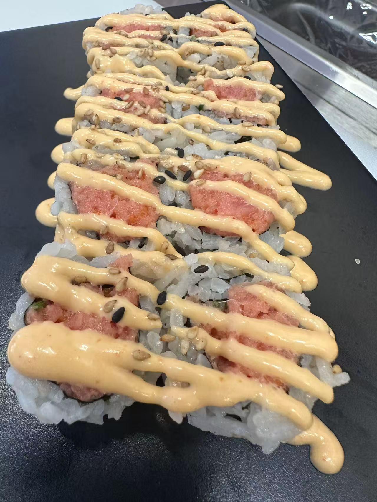 Spicy tuna roll with creamy sauce and sesame seeds at ZX Sushi, a Japanese Restaurant in Milwaukee